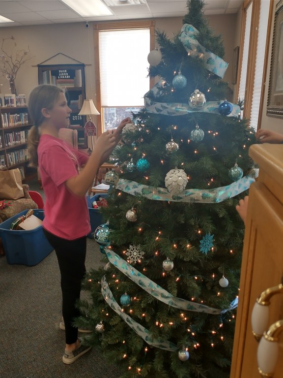 child decorating the library